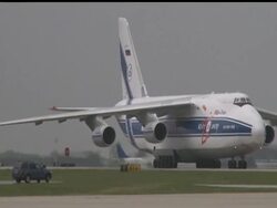 A massive Russian cargo plane roared into Atlanta on Friday to pick up one of the world's largest concrete pumps, which has been retrofitted to pour water on a Japanese nuclear power plant stricken by an earthquake and tsunami. News Clip