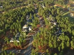 WS AERIAL ZO View of pinehurst golf courses with forest and houses / North Carolina, United States Stock Footage