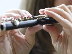 Woman playing piccolo flute Stock Footage