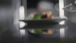 Chef places finished lobster entr_e on counter ready for service in restaurant kitchen Stock Footage