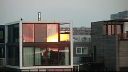 The Netherlands are notoriously flat and low lying, with 50% of the country lying below sea level. Climate change is leading to both sea level rise and increased flooding, both of which threaten properties. One solution is to build floating houses, that ri Stock Footage