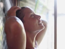 MS Young women showering in cabana on tropical vacation / Placencia, Stann Creek, Belize Stock Footage