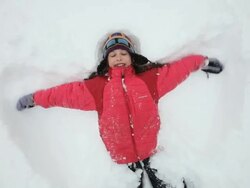 MS ZI ZO Girl creating snow angel during snowstorm / Yarmouth, Maine, USA Stock Footage