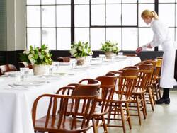 MS waitress setting banquet table for dinner party in loft Stock Footage
