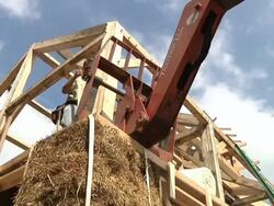 WS Carpenter helping fork lift operator during framing of an energy efficient post / Grass Lake, Michigan, USA Stock Footage