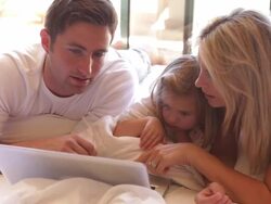 Family In Bed Using Laptop Stock Footage