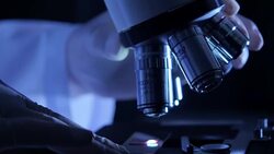 Scientist is using with microscope Stock Footage