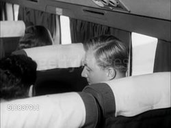 1950: TRANSPORTATION: MS Behind passengers sitting in seats in commercial DC-6. PREPARING FOR LANDING: CU Lighted 'No Smoking, Cigarettes Only Please, Fasten Seat Belts' sign. CU Male hands fastening seatbelt. Instructional Video