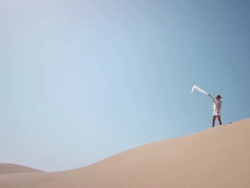 Woman with scarf in desert Stock Footage