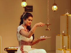 Young woman celebrating diwali festival with her daughter Stock Footage