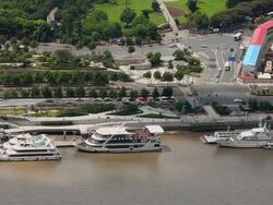 WS HA View of barges on Huangpu river and traffic on road / Shanghai,  China Stock Footage