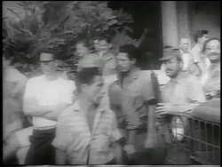 B/W 1959 line of guerrilla soldiers carrying guns walking past camera outdoors / Cuba / newsreel Stock Footage