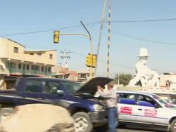 Drive-by large CCC statue in middle of road, Cochabamba, Bolivia Stock Footage