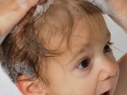 Child playing in bubble bath Stock Footage