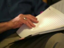 A close up shot of an elderly man thumbing through an old book. Stock Footage