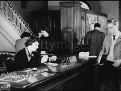 1949: DRAMATIZATION: Young teenage male entering library, checking in book w/ female front desk librarian & asking direction to American History section.  Public library. Instructional Video