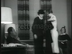 1936: DENTAL OFFICE: INT Dentist office w/ nurse helping female patient w/ coat. Nurse talking on telephone, smiling. VS Dentist waiting, reception room & patients. Instructional Video