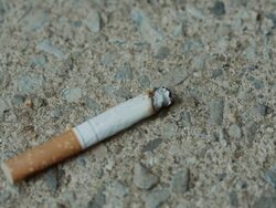 Foot turns off smoking cigarette Healthy choice on street sidewalk Stock Footage