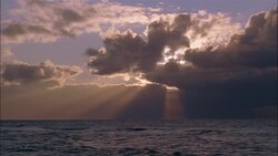 Sun beams stream down from clouds above the sea. Stock Footage