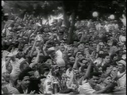 B/W 1959 crowd of people waving + cheering outdoors / post-revolution Havana / newsreel Stock Footage