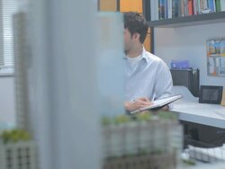 MS PAN Architect and colleague talking and working on blueprint in studio / Vancouver, BC, Canada Stock Footage