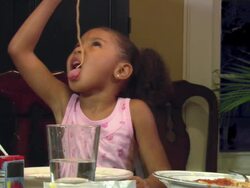MS, girl (4-5) eating spaghetti with her hands, Westfield, New Jersey, USA Stock Footage