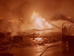 WS PAN Emergency workers holding back panicked people and firemen working / Unspecified Stock Footage