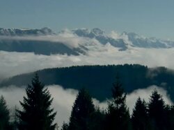 Extreme Long Shot static - Dense clouds roll over snowy mountaintops / Italy Stock Footage