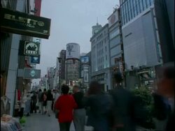 T/L nightfall on street, pedestrians and buildings, Ginza yon-chome,, Tokyo, Japan Stock Footage
