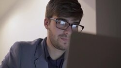 Using laptop, screen reflection in eyeglasses. Stock Footage
