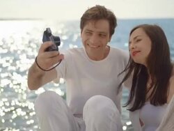 HD: Couple Taking Photos By The Sea Stock Footage