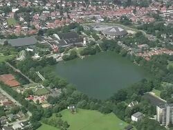 WS AERIAL PA ZI ZO View of Minnewater park and Onze lieve Vrouekerk in Bruges city / Flanders, Belgium Stock Footage