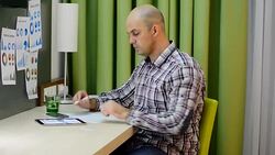 Casual businessman dealing with finances at home office Stock Footage