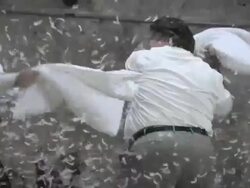 Businessmen fighting with feather pillows then hugging Stock Footage