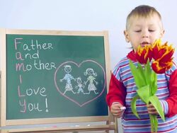 boy draws a card for parents Stock Footage