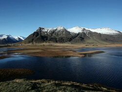 WS View of lagoon in front of snow covered mountain / Iceland  Stock Footage