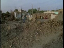 MS Pan left Gujarat, Indian families amongst rubble of collapsed homes, after earthquake, Gujarat, India Stock Footage