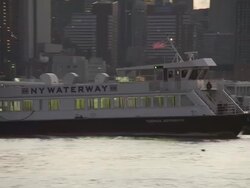 NY Waterway ferry on the hudson river turns and sets a course for manhattan with birds flying and the skyscrapers of new york city in the background Stock Footage