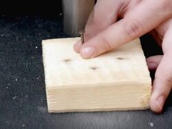 Hammering nail in board Stock Footage