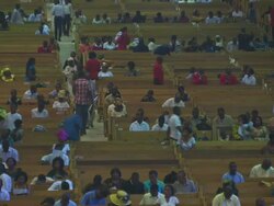 MS Large church interior people entering in church and other people siting on benches / Lagos, Nigeria Stock Footage