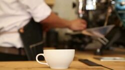 Close up cup of coffee beside machine Stock Footage