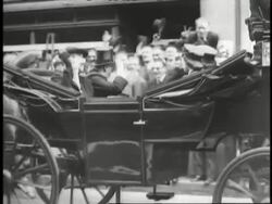 Prime Minister Winston Churchill flashes the victory sign to British crowds. News Clip