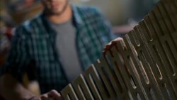 Woodworkers feel sanded edges of finished wooden frame in workshop Stock Footage