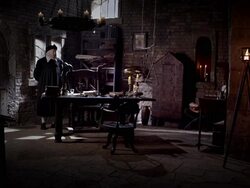 A fire flickers in a lamp as Nostradamus stands behind his desk. Stock Footage