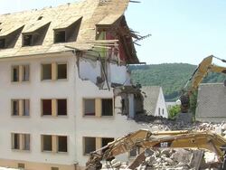 MS Two bulldozers at demolition of apartment block / Saarburg, Rhineland-Palatinate, Germany Stock Footage