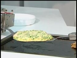 Japanese engineers demonstrated robots that can cook and serve food and drinks. News Clip
