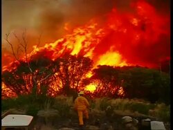 MWA high angle, Bush fire fighters battling flames Stock Footage