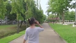 Woman talking on the phone;Steadicam Shot Slowmotion Stock Footage