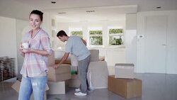 Portrait of smiling woman drinking coffee near moving boxes Stock Footage