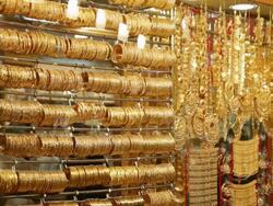 MS Lots of gold bangles and jewelry hanging in jewellry shop / Dubai,  United Arab Emirates Stock Footage